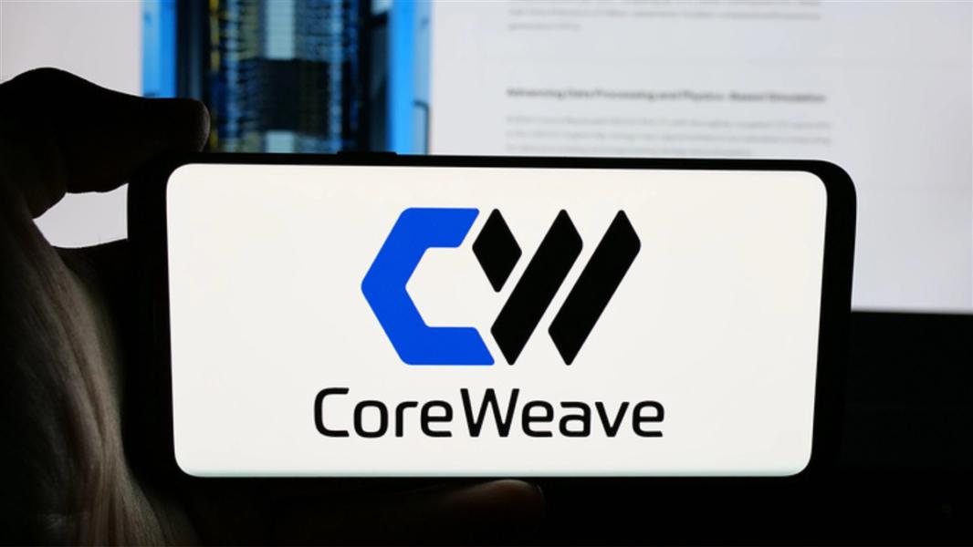 CoreWeave Inc. on screen in front of webpage. Focus on phone display.