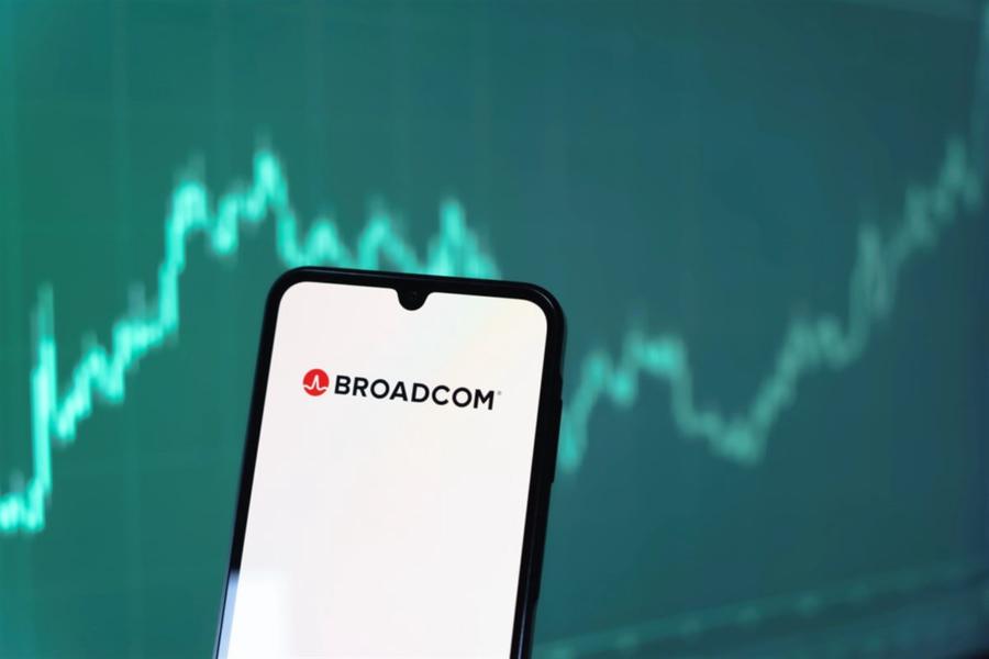 Broadcom logo on smartphone with stock chart background